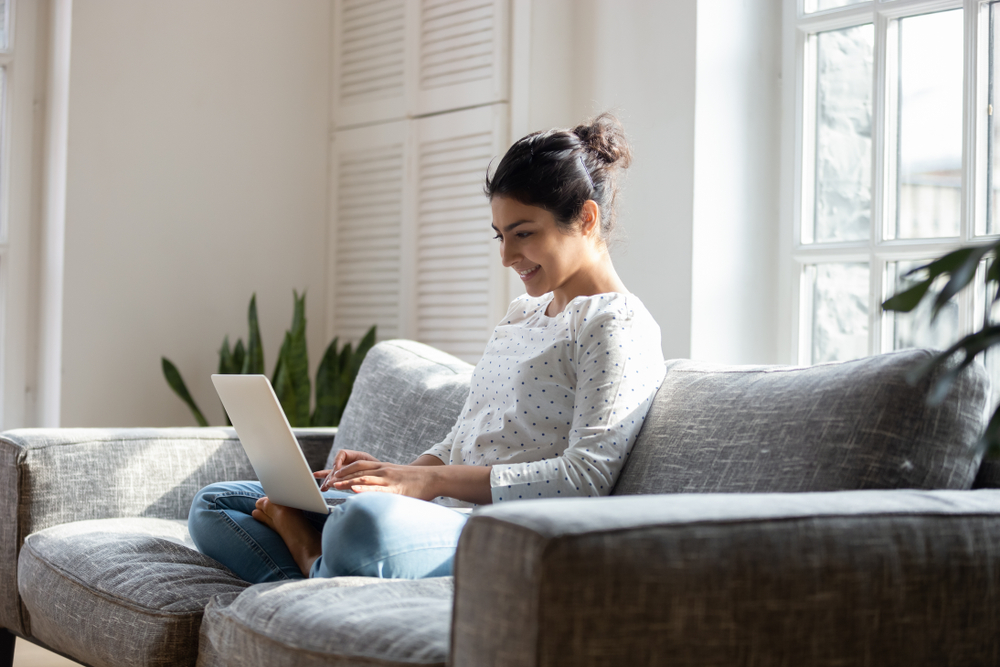 Young Woman Doing Online Surveys In Spare Time